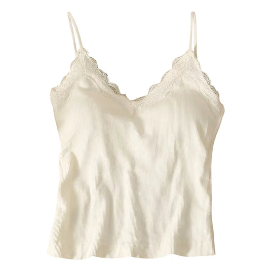 The Womens Crop Top Korean Version is a white, sleeveless camisole with spaghetti straps and lace along the V-neckline. Made from soft, textured fabric, it’s perfect for layering or wearing alone.